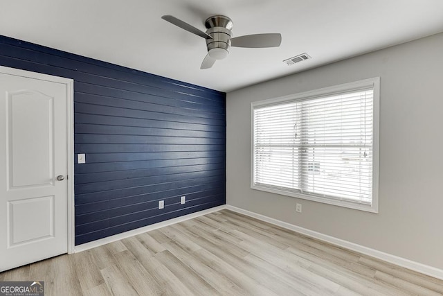 9565 Rushmore Cir, Braselton, GA 30517 - spare room featuring ceiling fan, light wood finished floors, wooden walls, and baseboards
