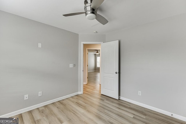 9565 Rushmore Cir, Braselton, GA 30517 - unfurnished bedroom featuring light wood finished floors, baseboards, and a ceiling fan