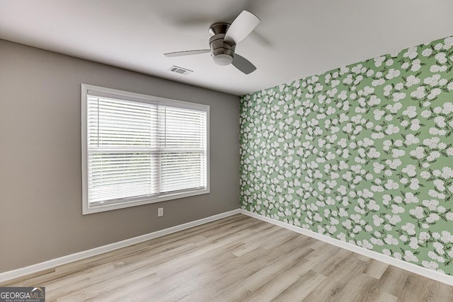 9565 Rushmore Cir, Braselton, GA 30517 - spare room featuring wood finished floors, ceiling fan, and baseboards