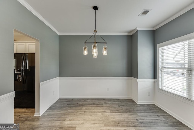 9565 Rushmore Cir, Braselton, GA 30517 - unfurnished dining area with wood finished floors and ornamental molding