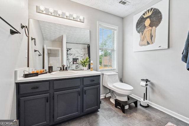 2349 June Springs Dr SW, Marietta, GA 30008 - full bathroom with toilet, vanity, baseboards, a shower, and a textured ceiling