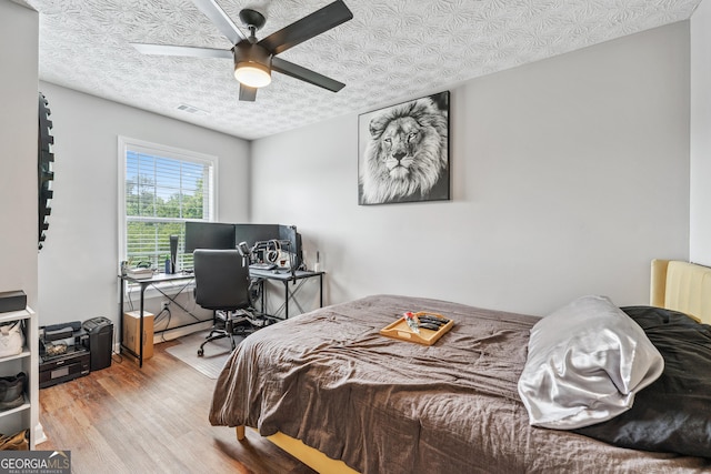 2349 June Springs Dr SW, Marietta, GA 30008 - bedroom featuring wood finished floors, a desk, and ceiling fan
