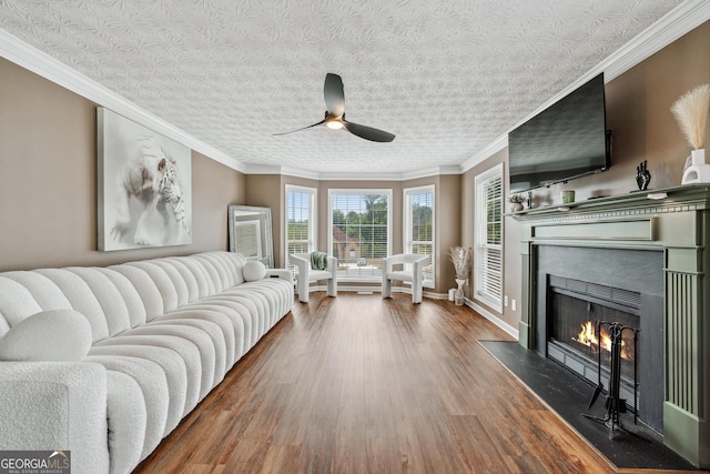 2349 June Springs Dr SW, Marietta, GA 30008 - living room featuring a ceiling fan, wood finished floors, a warm lit fireplace, baseboards, and crown molding