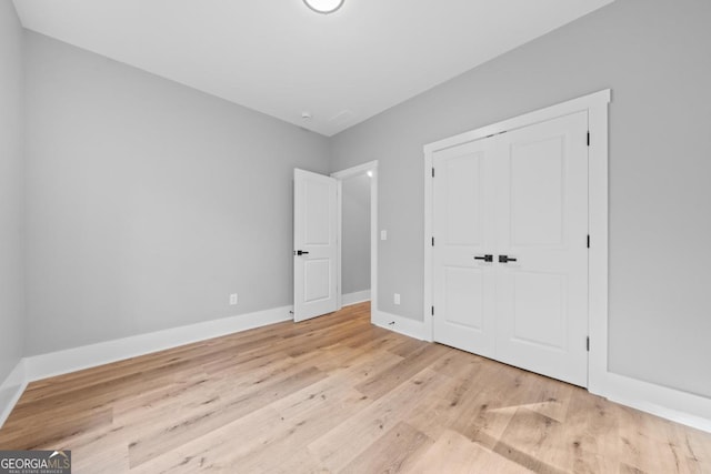 103 Spruce Ln, Eatonton, GA 31024 - unfurnished bedroom with light wood-style flooring and a closet