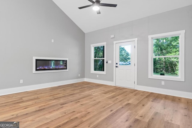 103 Spruce Ln, Eatonton, GA 31024 - unfurnished living room with high vaulted ceiling, ceiling fan, and light wood-style flooring
