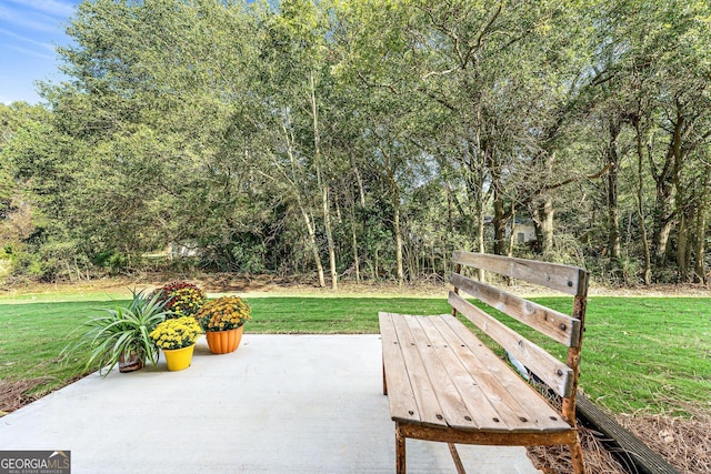 view of property featuring a garage, driveway, a front lawn, and stone siding
