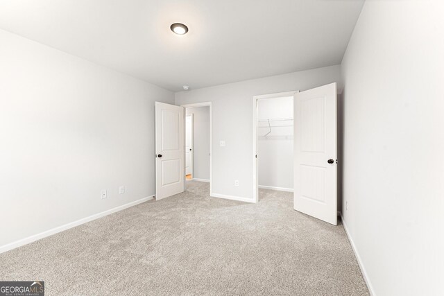88 Ridge Way Unit 41, Hartwell, GA 30643 - unfurnished bedroom with baseboards, light carpet, a spacious closet, and a closet