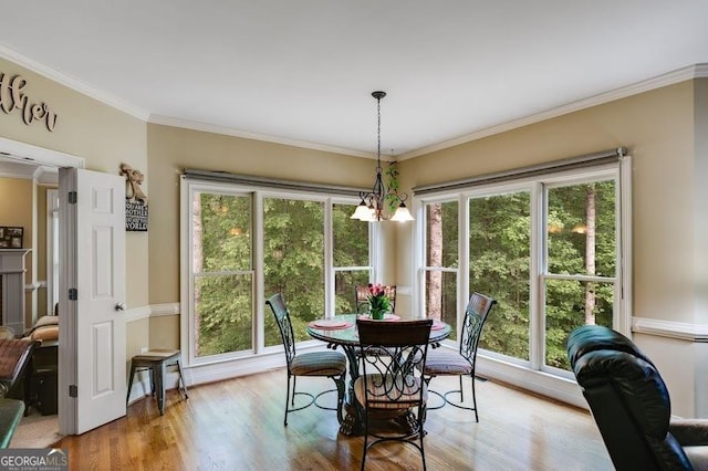 7511 Biltmore Ln, Douglasville, GA 30135 - dining room with a chandelier, wood finished floors, and crown molding