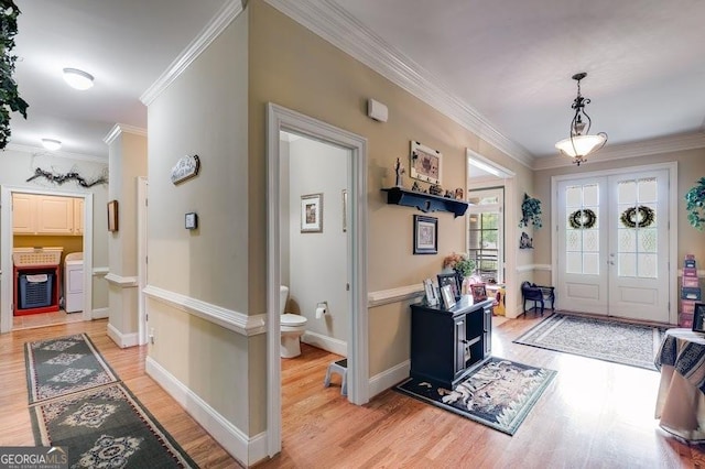 7511 Biltmore Ln, Douglasville, GA 30135 - foyer entrance with light wood-style floors, crown molding, washing machine and clothes dryer, french doors, and baseboards