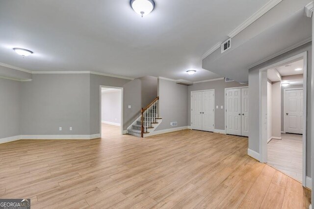 7511 Biltmore Ln, Douglasville, GA 30135 - below grade area with stairway, light wood finished floors, baseboards, and crown molding