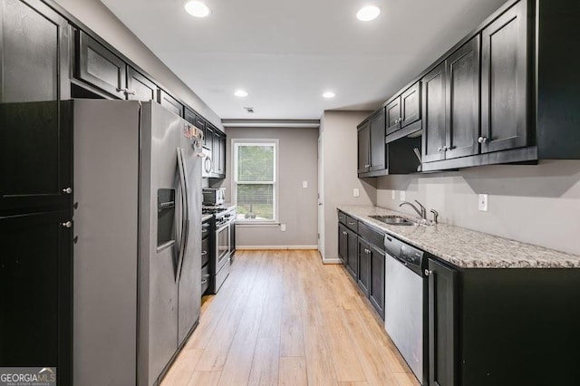 7511 Biltmore Ln, Douglasville, GA 30135 - kitchen featuring a sink, stainless steel appliances, light wood-style flooring, recessed lighting, and baseboards