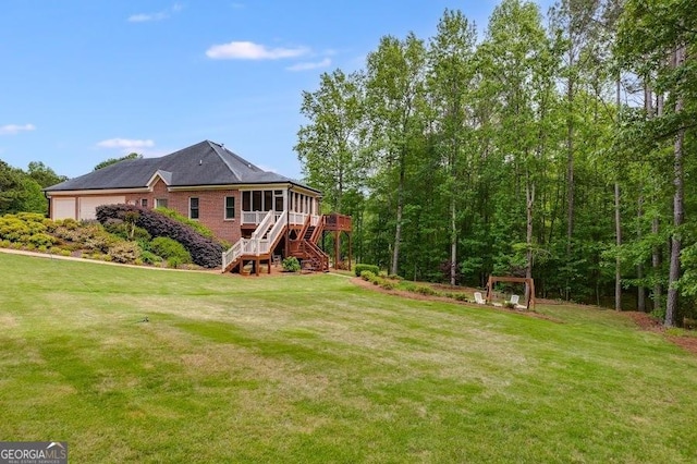 7511 Biltmore Ln, Douglasville, GA 30135 - view of green lawn featuring stairs, a sunroom, an attached garage, and a deck