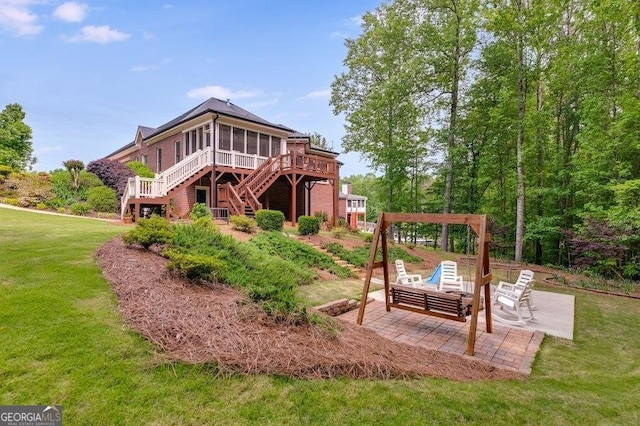 7511 Biltmore Ln, Douglasville, GA 30135 - back of house featuring stairway, a sunroom, a patio area, a deck, and a lawn