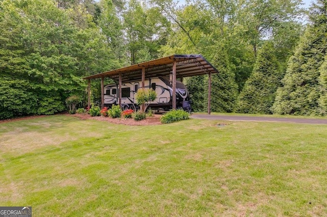 7511 Biltmore Ln, Douglasville, GA 30135 - view of grassy yard featuring a carport and asphalt driveway