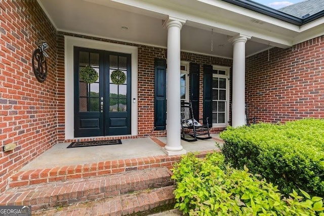 7511 Biltmore Ln, Douglasville, GA 30135 - entrance to property featuring french doors, brick siding, and covered porch