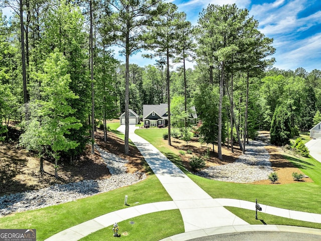 view of home's community featuring a lawn
