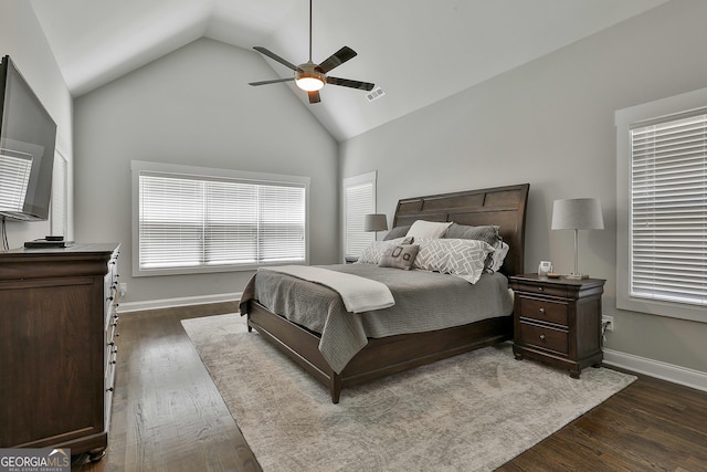bedroom featuring dark wood-style flooring, ceiling fan, baseboards, and high vaulted ceiling