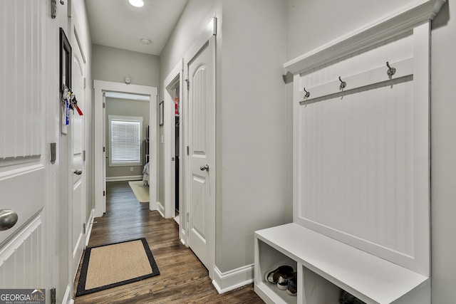 mudroom featuring dark wood-style floors and baseboards