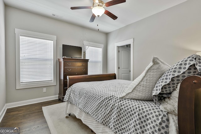 bedroom with wood finished floors, baseboards, and ceiling fan