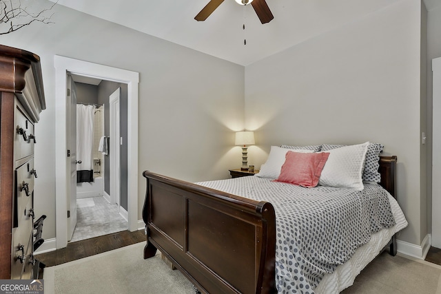 bedroom featuring baseboards, wood finished floors, and ceiling fan