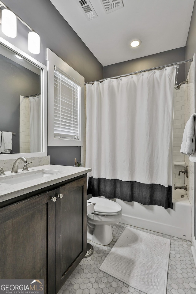 bathroom featuring toilet, shower / bath combination with curtain, vanity, and recessed lighting