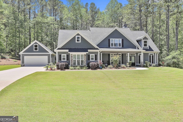 craftsman house featuring covered porch, a front yard, and driveway