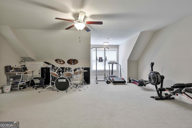 exercise area with a ceiling fan and carpet