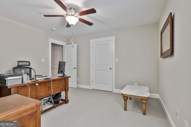 office with ceiling fan, light carpet, and baseboards