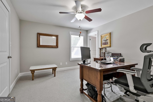office featuring ceiling fan, light colored carpet, and baseboards