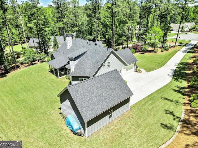 view from above of property with a tree filled landscape
