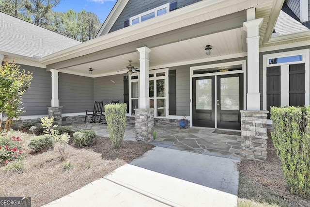 property entrance with a porch, a ceiling fan, and roof with shingles