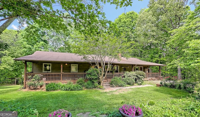 ranch-style home with covered porch and a front lawn
