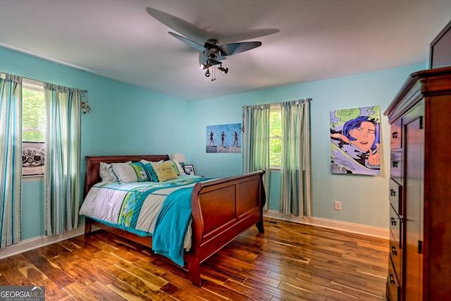 bedroom featuring wood finished floors, ceiling fan, and baseboards