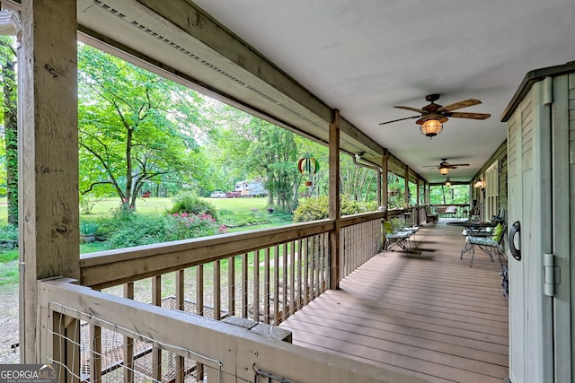 wooden deck featuring ceiling fan