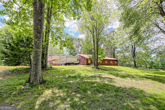view of yard with view of wooded area