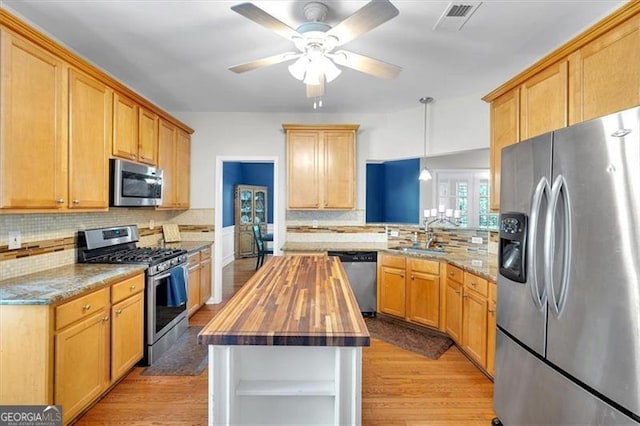 10 Bayberry Ct, Acworth, GA 30101 - kitchen with appliances with stainless steel finishes, butcher block countertops, a sink, ceiling fan, and tasteful backsplash