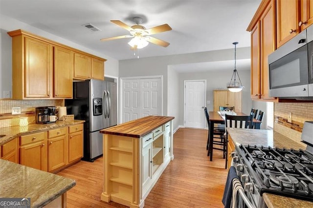 10 Bayberry Ct, Acworth, GA 30101 - kitchen with appliances with stainless steel finishes, open shelves, a ceiling fan, and backsplash