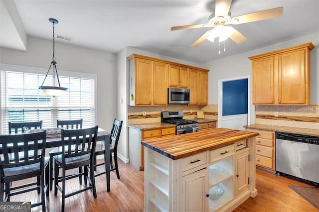 10 Bayberry Ct, Acworth, GA 30101 - kitchen with stainless steel appliances, butcher block counters, backsplash, a ceiling fan, and light wood finished floors