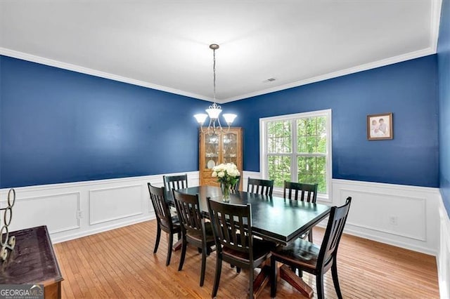 10 Bayberry Ct, Acworth, GA 30101 - dining room featuring a wainscoted wall, a chandelier, hardwood / wood-style floors, ornamental molding, and a decorative wall