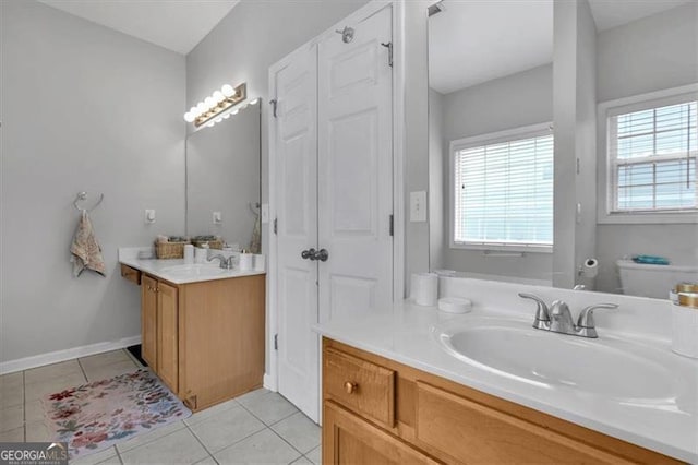 10 Bayberry Ct, Acworth, GA 30101 - bathroom featuring tile patterned floors, two vanities, toilet, and baseboards