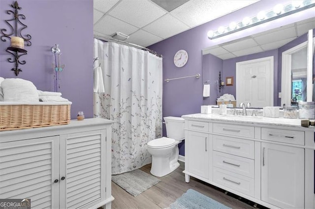 10 Bayberry Ct, Acworth, GA 30101 - full bath featuring a drop ceiling, wood finished floors, toilet, vanity, and a shower with shower curtain