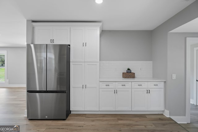 2604 Flat Shoals Rd SW, Conyers, GA 30094 - kitchen with freestanding refrigerator, white cabinetry, light countertops, light wood finished floors, and recessed lighting