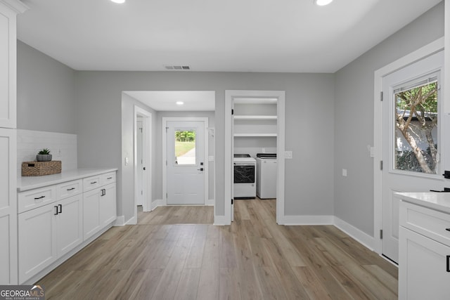 2604 Flat Shoals Rd SW, Conyers, GA 30094 - foyer entrance featuring separate washer and dryer, light wood finished floors, recessed lighting, and baseboards