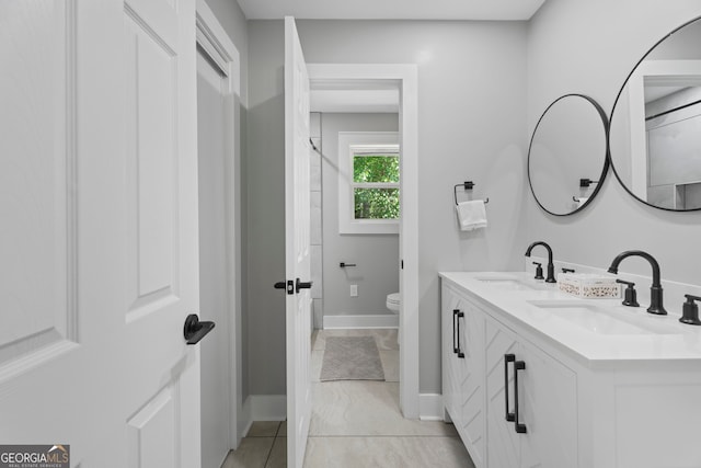 2604 Flat Shoals Rd SW, Conyers, GA 30094 - bathroom with toilet, double vanity, baseboards, and a shower