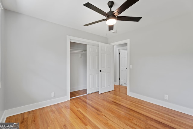 2604 Flat Shoals Rd SW, Conyers, GA 30094 - unfurnished bedroom featuring baseboards, light wood-type flooring, a closet, and a ceiling fan
