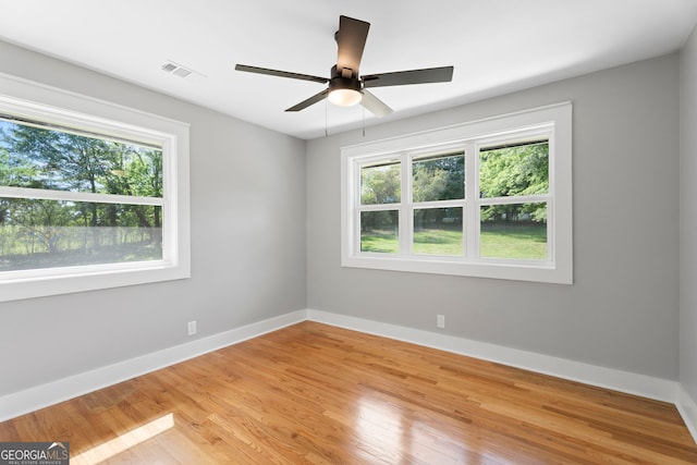 2604 Flat Shoals Rd SW, Conyers, GA 30094 - empty room featuring light wood-style flooring, baseboards, and a ceiling fan