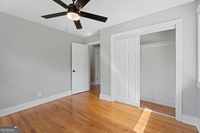 2604 Flat Shoals Rd SW, Conyers, GA 30094 - unfurnished bedroom with baseboards, light wood-style flooring, a closet, and a ceiling fan