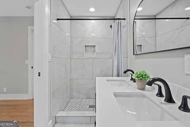 2604 Flat Shoals Rd SW, Conyers, GA 30094 - bathroom with a stall shower, wood finished floors, recessed lighting, double sink, and baseboards