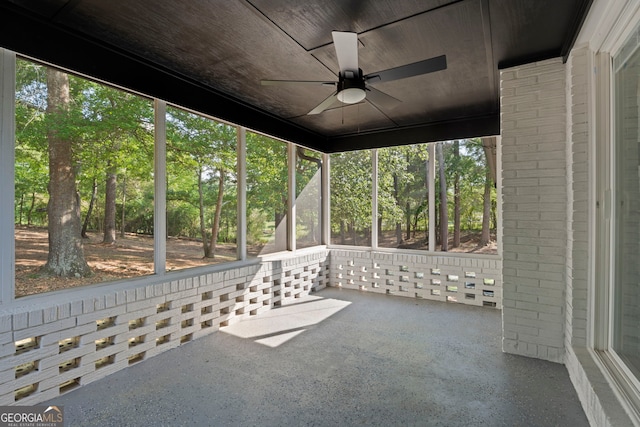 2604 Flat Shoals Rd SW, Conyers, GA 30094 - unfurnished sunroom with a ceiling fan, plenty of natural light, and view of wooded area