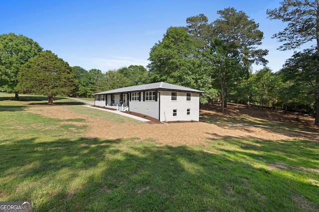 2604 Flat Shoals Rd SW, Conyers, GA 30094 - back of house with a lawn and a wooded view